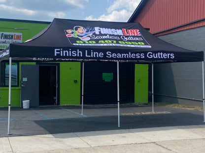 Custom racing canopy with team logo at motorsport event. Finish Line Seamless Gutters. P1 Covers. P1 Performance. P1 Protection.