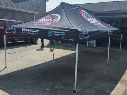 Racing canopy with a custom logo displayed prominently, providing shade and shelter in the pit area. The sturdy, high-quality structure features vibrant branding, showcasing the team's identity and enhancing their presence at the racetrack.
